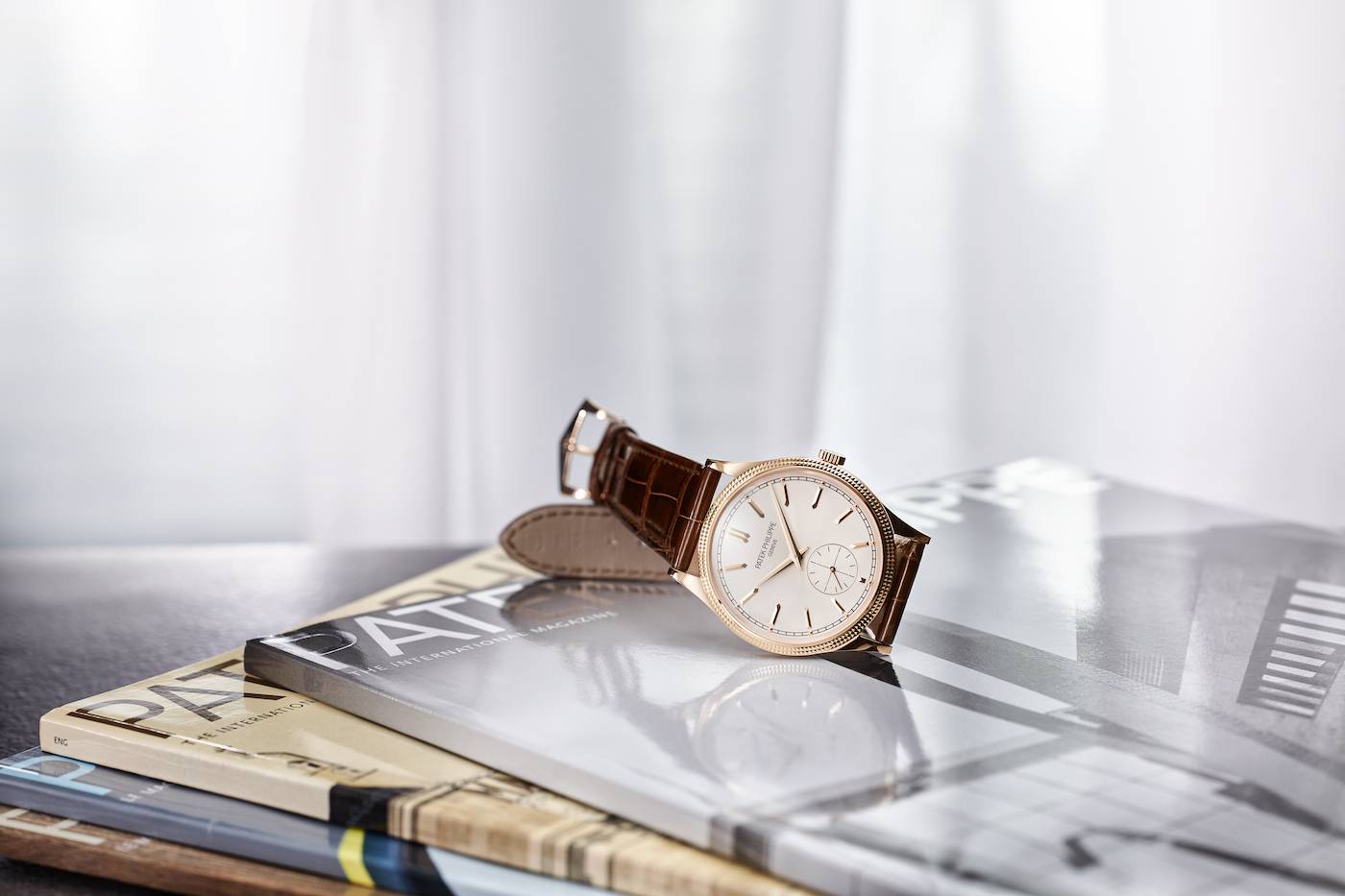 Patek Philippe's most contemporary Calatrava comes in two versions: the Ref. 6119R-001 (pictured here) combines a rose-gold case with a silvery grained dial as well as applied hour markers and hands in rose gold. The Ref. 6119G-001 in white gold subtly plays with light on a charcoal gray dial with attractive contrasts – a vertical satin finish interrupted by the snailed subsidiary seconds dial.