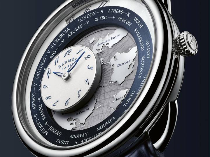 Créée en 2022, Arceau Le Temps voyageur s'habille aujourd'hui d'or blanc et d'or rose. Un disque circulaire affichant 24 fuseaux horaires indique l'heure du domicile à 12 heures, tandis qu'un compteur mobile indique l'heure locale. Le tout est animé par un module exclusif de 122 composants, intégré au mouvement mécanique à remontage automatique de manufacture Hermès H1837.